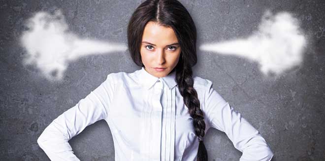 Mad young woman with steam coming out of ears on textured concrete background. Anger issues concept