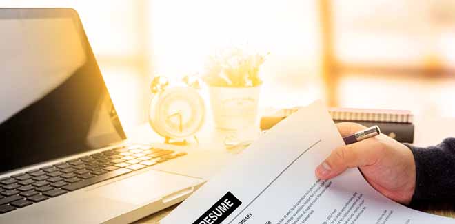 resume-photo Businessman or job seeker review his resume on his desk before send to finding a new job with pen, necktie, glasses and digital tablet.