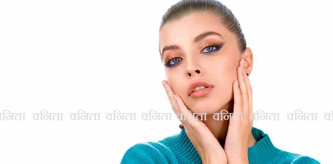 Portrait of beautiful young woman with perfect young skin, red matt lips in white fur.  Model with bright scarlet color makeup and sparkled manicure posing on light blue background. 