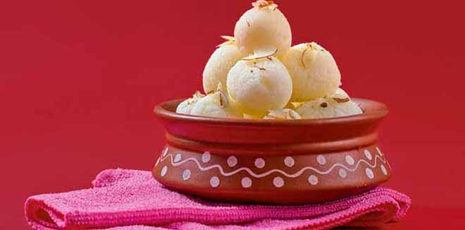 Indian Sweet or Dessert - Rasgulla, Famous Bengali sweet in clay bowl with napkin on Red Background
