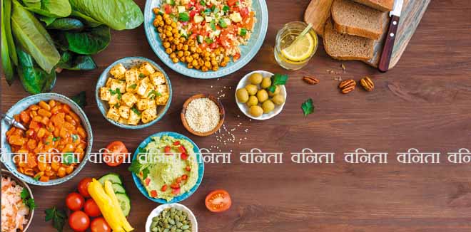 Vegan dinner table, set of healthy vegan vegetarian dishes for lunch - quinoa and chickpea salad, fried tofu, hummus dip, fruits, vegetables, nuts, seeds, top view, copy space, flat lay.