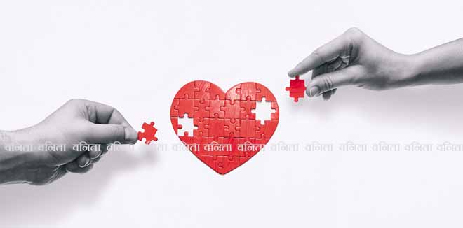 Two people put together a heart-shaped puzzle. The concept of building love relationships.