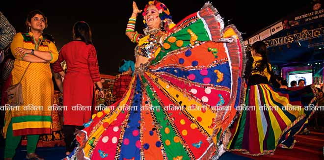 dussehra-4 Mumbai, India - October 16, 2015 - Female dancers  in traditional colorful Indian costume on the floor among crowd during Navratri (nine-day) dance Festival