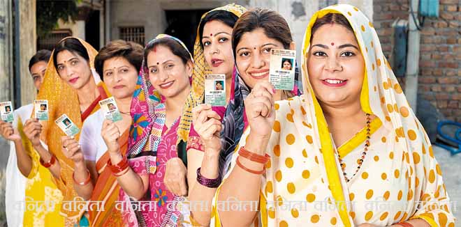 Group of happy traditional indian women standing in queue showing voter card id to cast vote at polling station. Election in india.
