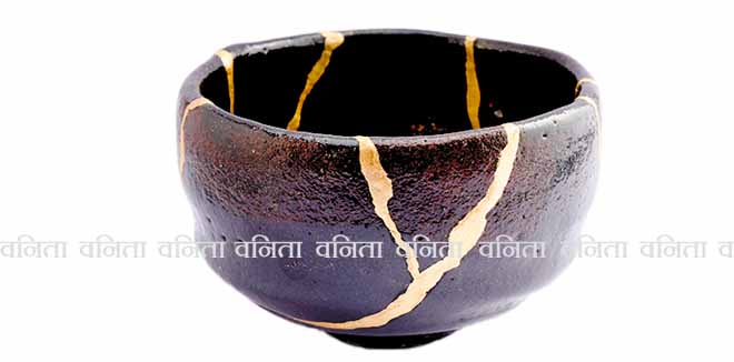 Kintsugi black raku chawan bowl. Gold cracks restoration on old Japanese pottery restored with the antique restoration technique.The unique beauty of imperfections. 